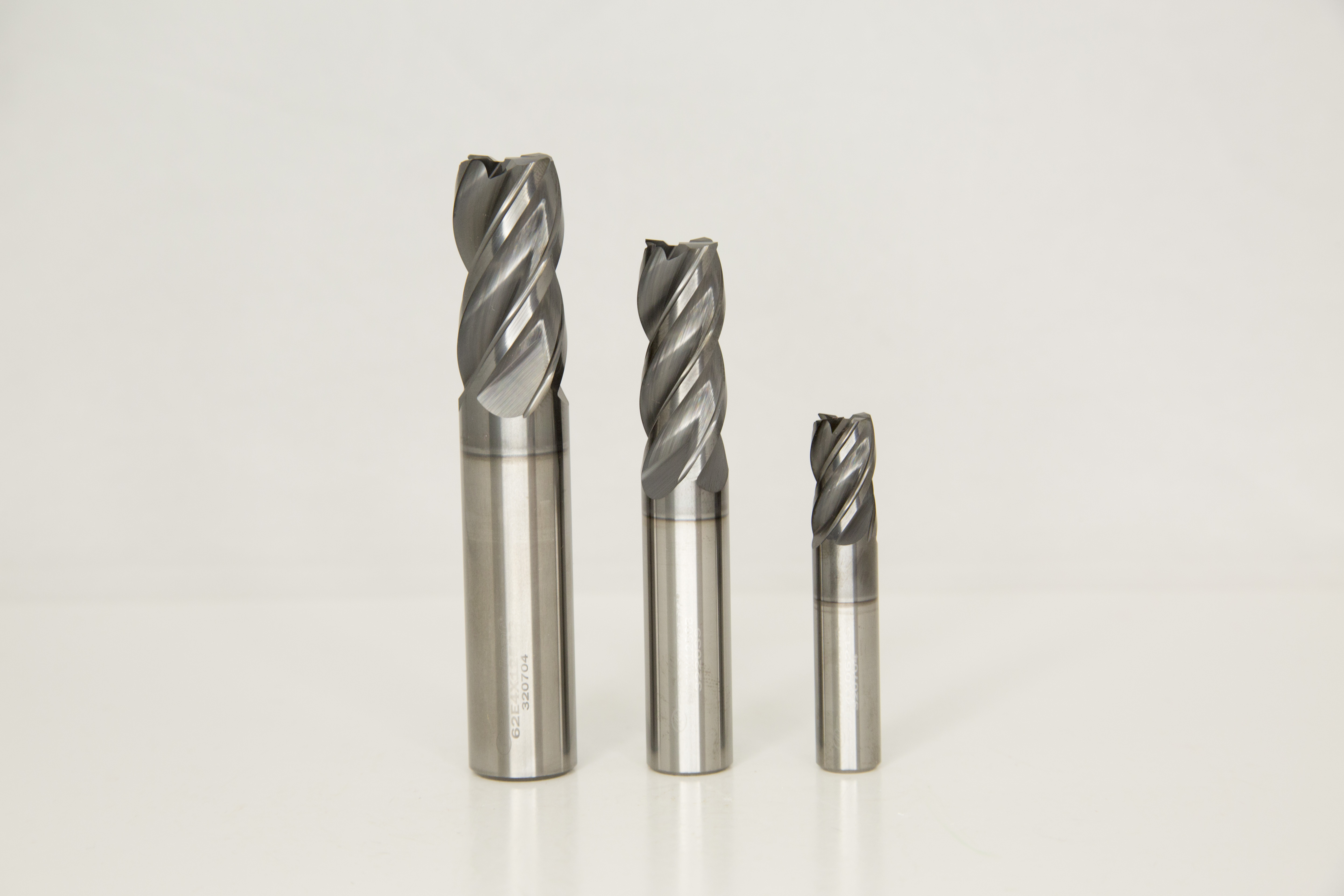 A photograph of three, 4 Flute Greenleaf-360 tools